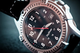 Close-up of luxury dive watch with black dial and leather strap