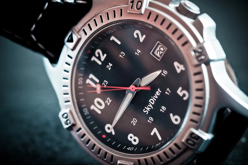 Close-up of luxury dive watch with black dial and leather strap
