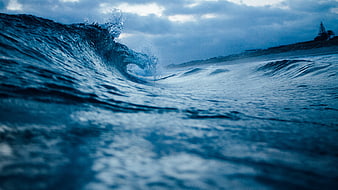 Dramatic Blue Ocean Wave Crashing Near Shoreline