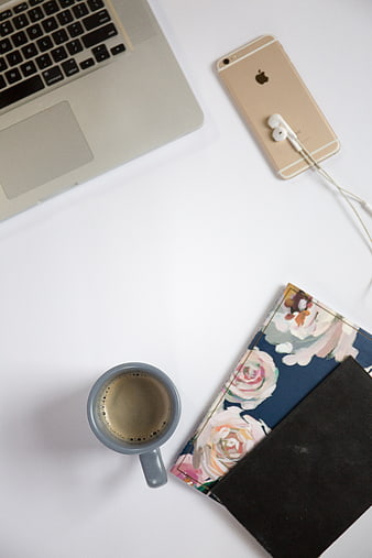 Flat lay workspace with laptop, coffee, and smartphone