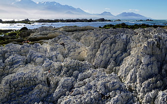 Rugged Rocky Coastline with Distant Mountains and Ocean