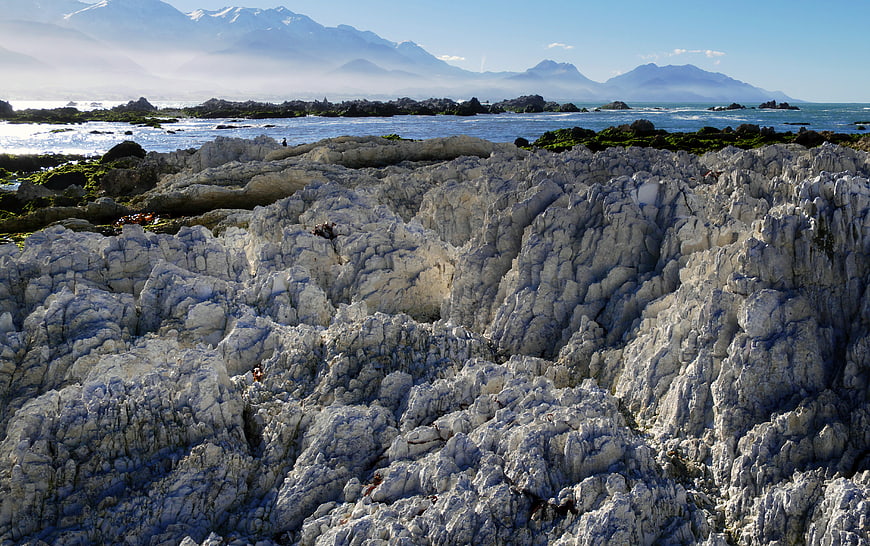 Rugged Rocky Coastline with Distant Mountains and Ocean