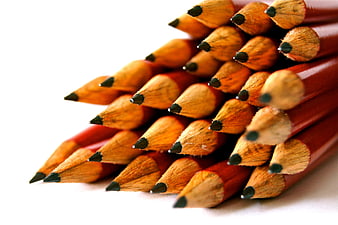 Close-up of red wooden pencils with graphite tips on white background