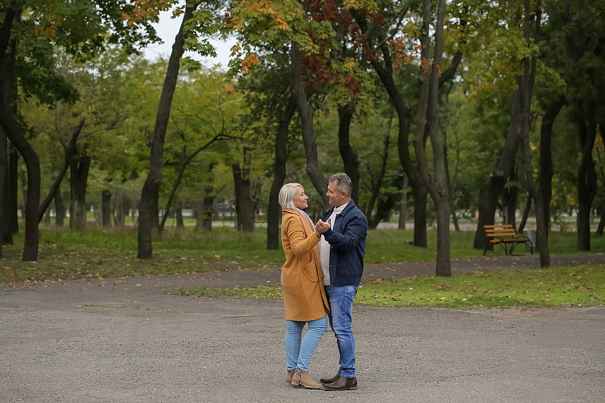 Senior couple dancing together in an autumn park