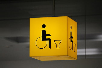 Yellow Hanging Accessible Toilet Sign with Wheelchair Icon