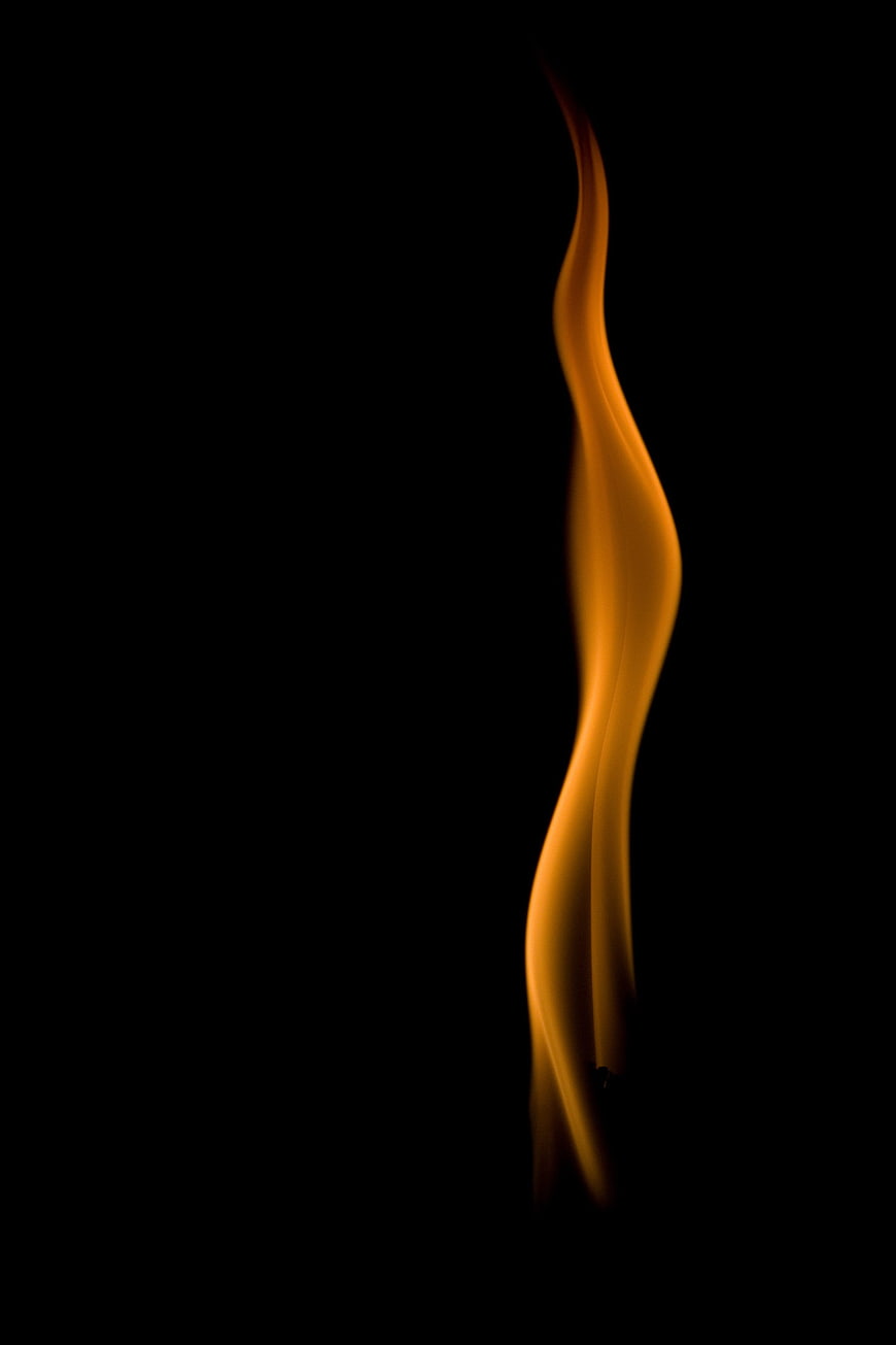 Single Orange Flame on Black Background