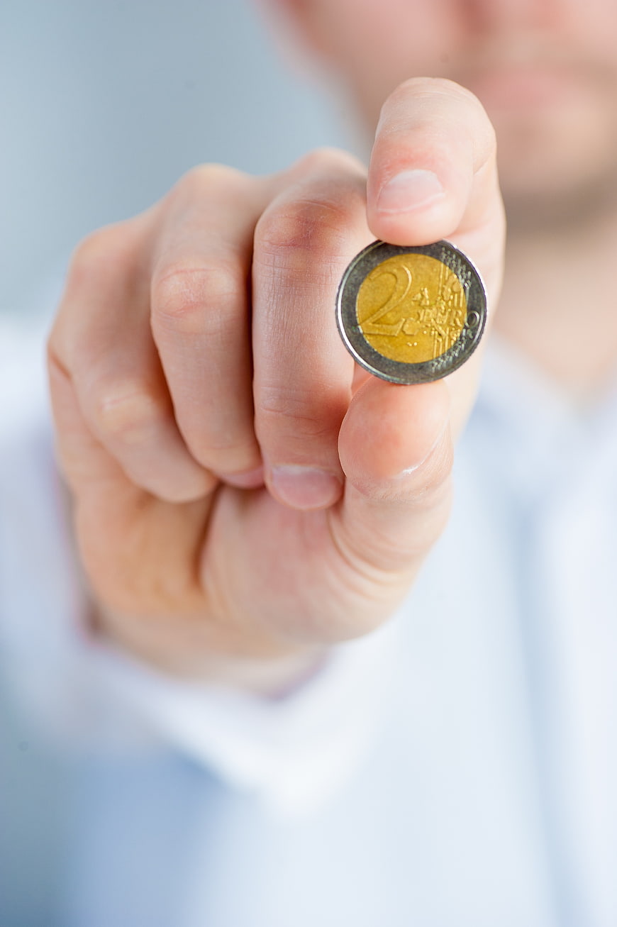 Hand Holding Two Euro Coin Close Up