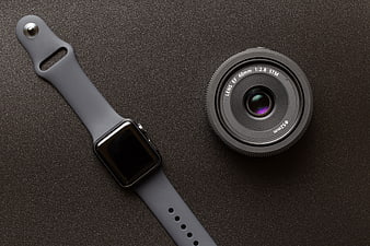 Smartwatch and Camera Lens Flat Lay on Dark Background