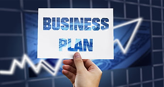 Hand holding business plan sign with financial growth chart background