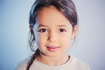 Close-up portrait of a cute young girl with a gentle smile