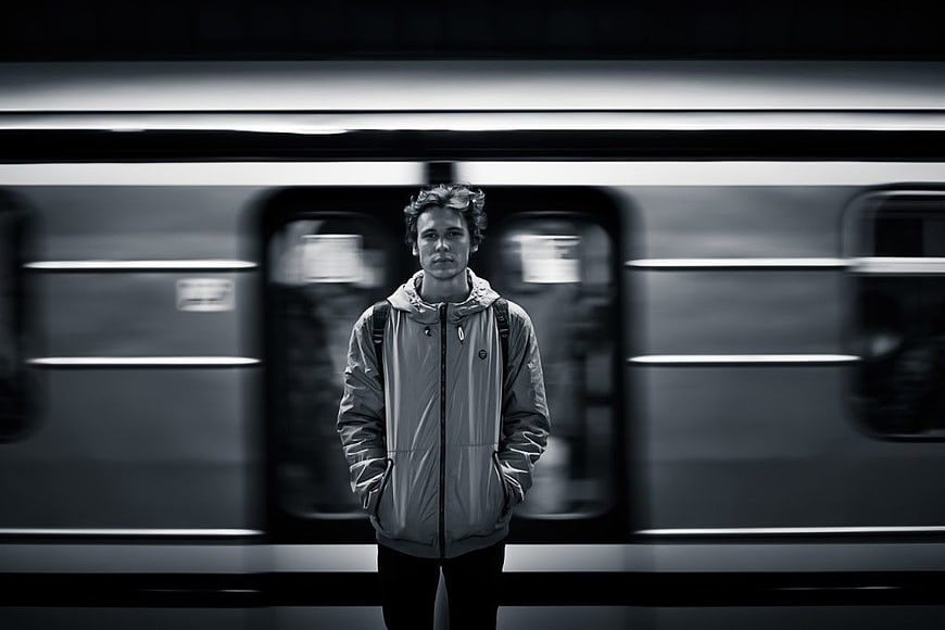 Man Standing in Front of Moving Train