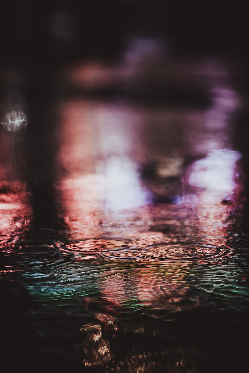 Abstract Night Water Ripples with Neon City Reflections
