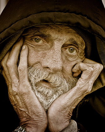 Close-up portrait of elderly homeless man with weathered face