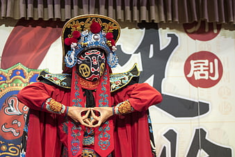 Sichuan Opera Performer in Traditional Mask and Costume