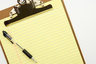 Yellow Lined Paper on Clipboard with Pen