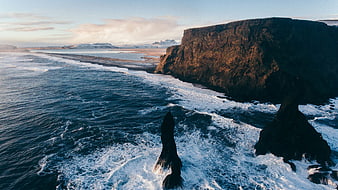 Dramatic coastal cliffs and sea stacks at sunset