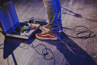 Musician's feet with guitar pedals on stage