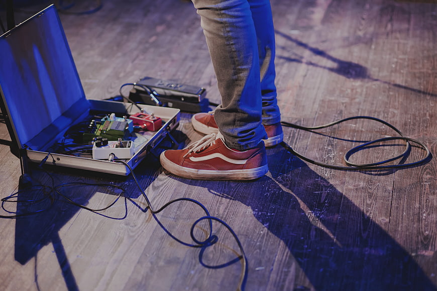 Musician's feet with guitar pedals on stage