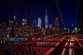 Brooklyn Bridge and Manhattan Skyline at Night with Light Trails