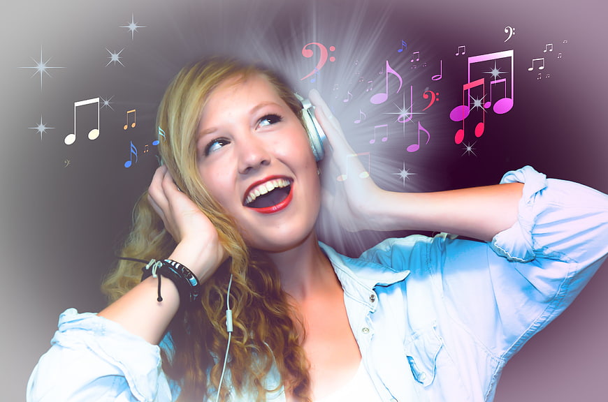 Happy woman listening to music with headphones and notes