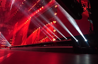 Dramatic red and white stage lights at a concert venue
