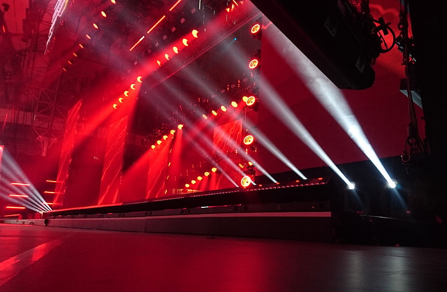 Dramatic red and white stage lights at a concert venue