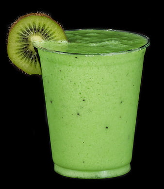 Green Kiwi Smoothie in Glass with Fresh Slice Garnish on Black Background