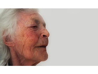 Close-up profile portrait of an elderly woman with white hair