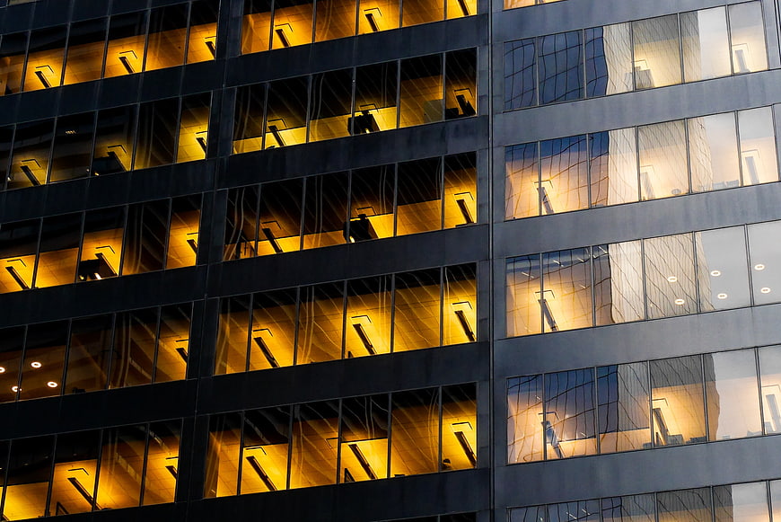 Modern office building facade with warm interior lights
