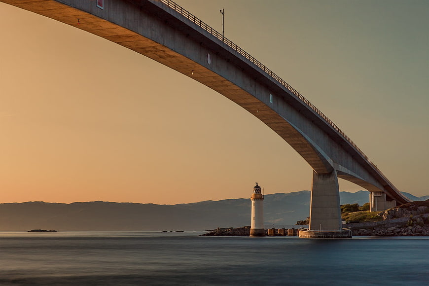 Skye Bridge and Lighthouse at Sunset Over Calm Sea