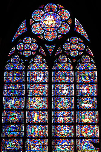 Gothic stained glass window with vibrant religious scenes
