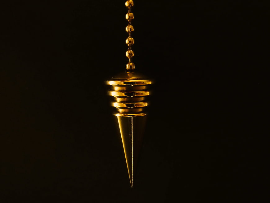Hanging Gold Plumb Bob Pendant on Black Background