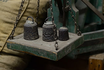 Rusty metal weights on vintage wooden balance scale