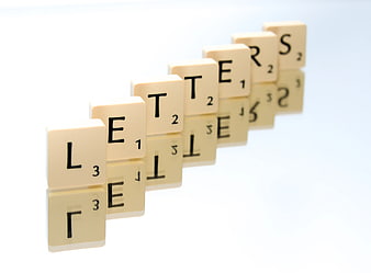 Scrabble Tiles Spelling Letters on White Background