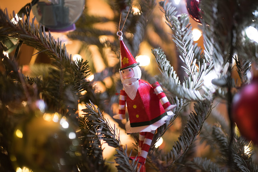 Close-up of Wooden Santa Claus Ornament on Christmas Tree
