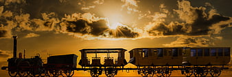Vintage steam train silhouette against dramatic golden sunset sky