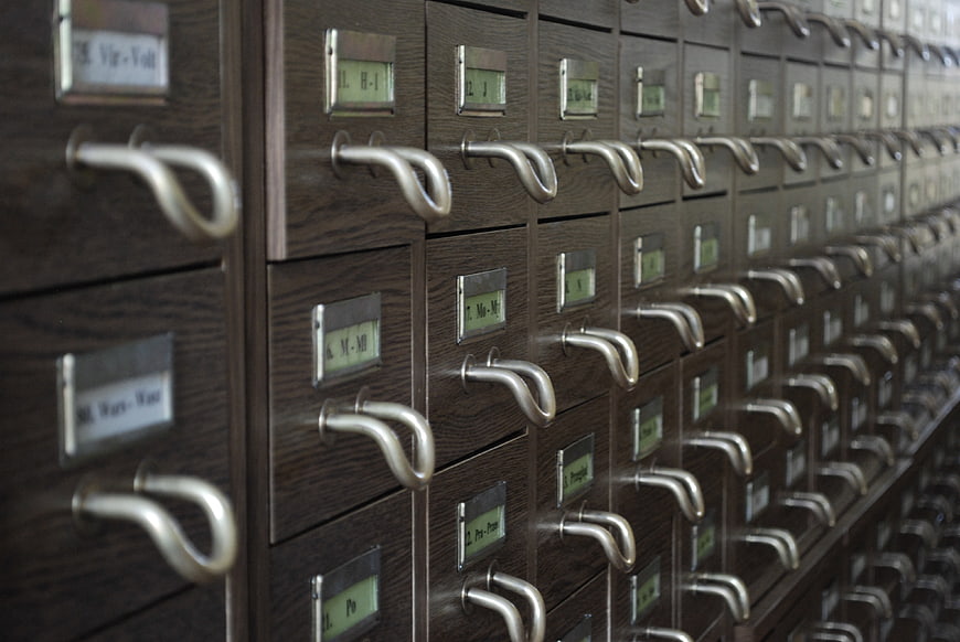 Vintage wooden library card catalog drawers with metal handles