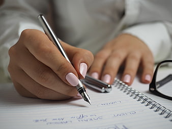 Woman Writing in Notebook with Fountain Pen