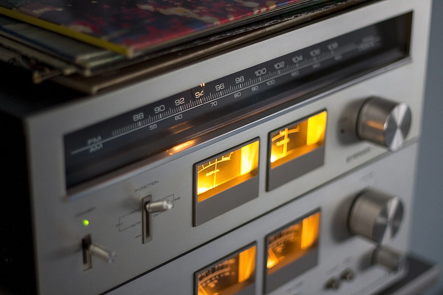 Vintage Stereo Receiver with Glowing VU Meters and Vinyl Records