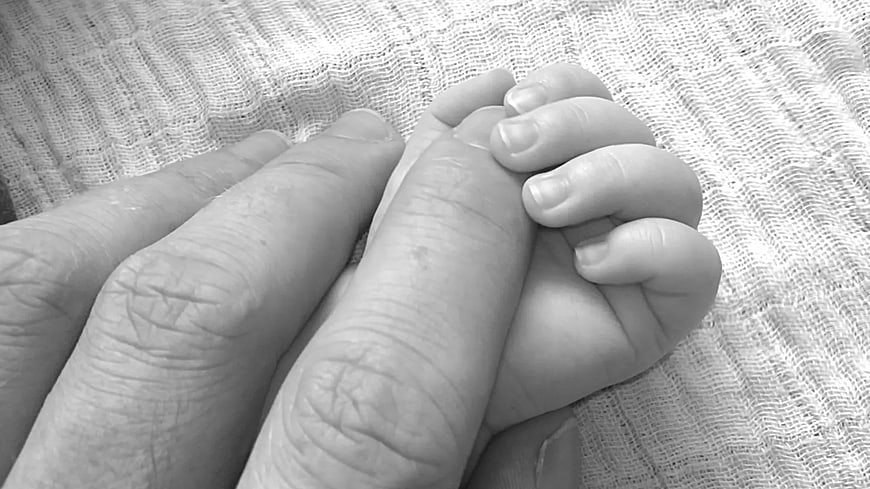 Black and White Close Up of Adult and Baby Hands Holding