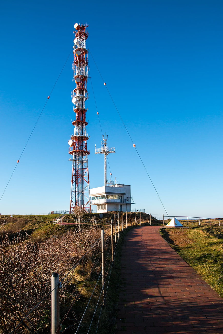 Red and white radio mast on Helgoland island with blue sky