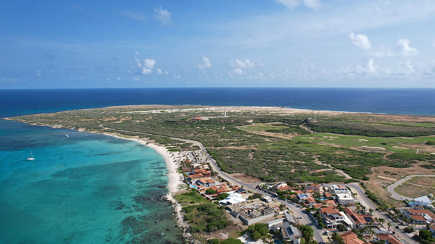Aerial View of Tropical Coastal Town and Turquoise Ocean