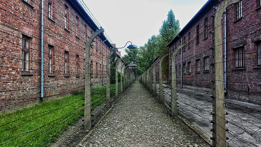 Auschwitz Concentration Camp Barbed Wire Fence and Brick Barracks