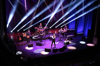 Live Rock Band Performance On Stage With Dramatic Blue Lighting