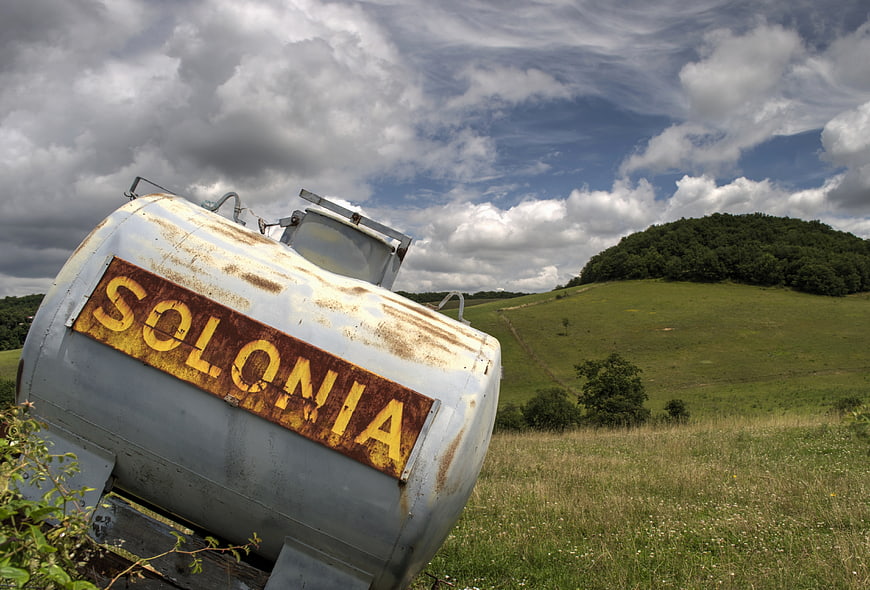 Rusty Solonia Water Tank in Green Pastoral Landscape