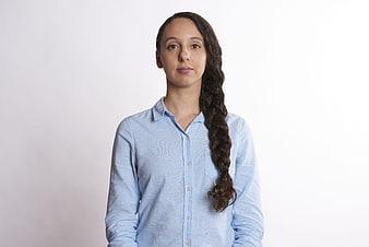 Portrait of young woman with braid in blue shirt