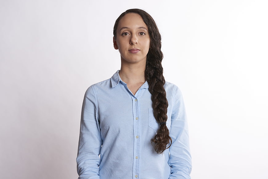 Portrait of young woman with braid in blue shirt