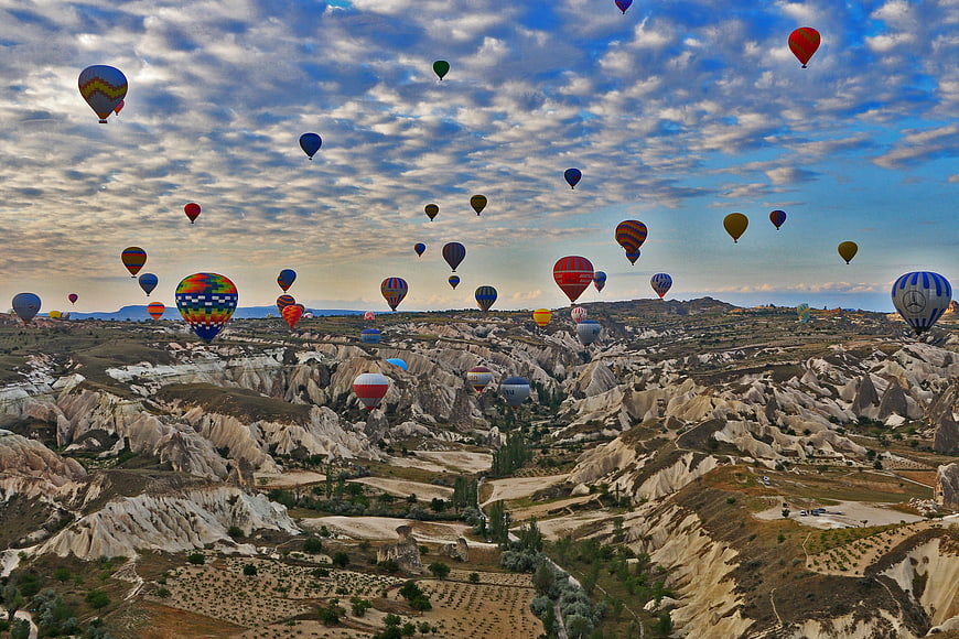 Hot Air Balloons Flying Over Cappadocia Landscape