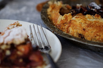 Homemade fruit pie slice on plate with fork