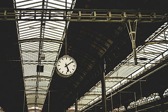Vintage Clock Hanging in Industrial Train Station Ceiling